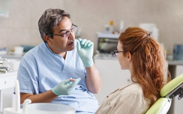 Dentist talking to patient during dental check up